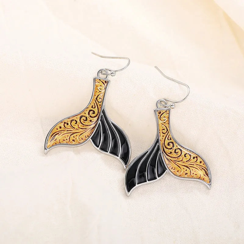 Women's white gold fishtail earrings with whale elements and retro styling