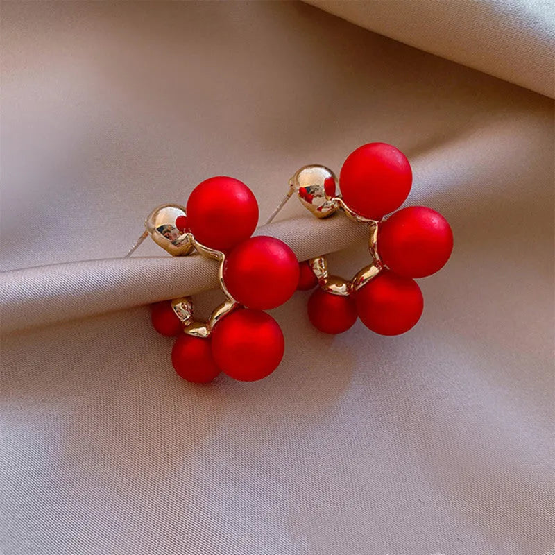 Alloy drop earrings for women with a red bell pendant on a silver-toned chain