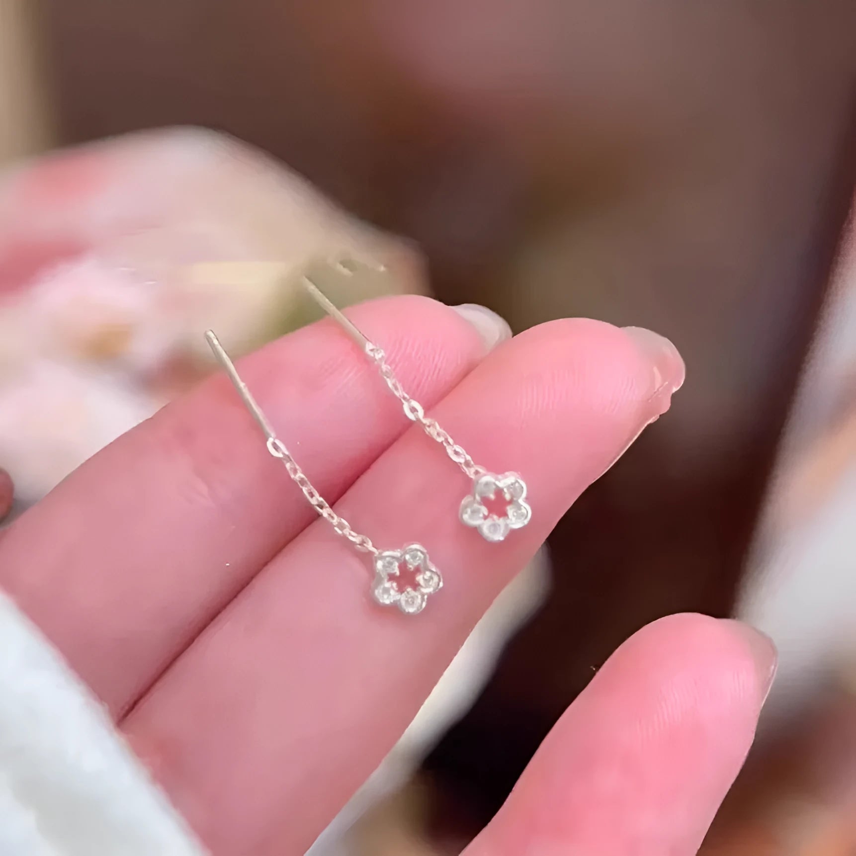 Silver flower stud earrings with hollow petal designs on alloy posts for women