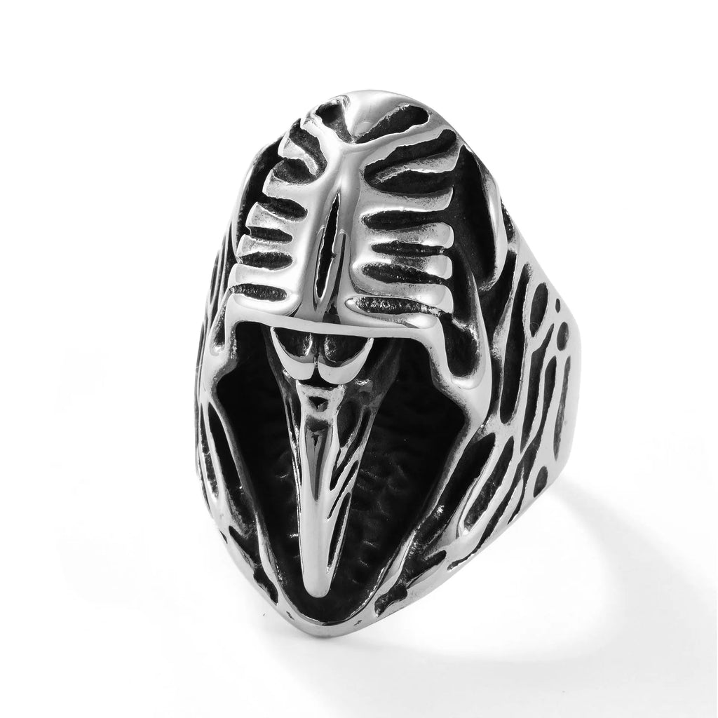 Geometric titanium steel crow ring in punk style on a grey background.