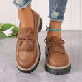 Plus size women's black loafers with tassel decoration and bowknot detail on round toe