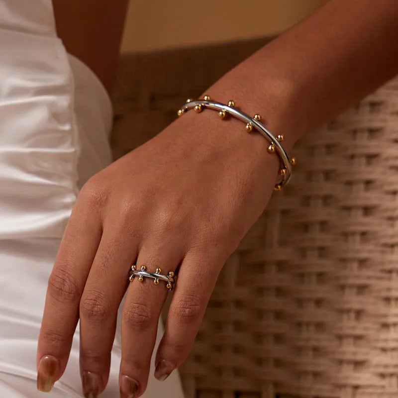 Stainless steel bracelet with textured bean beads and C-shaped adjustable closure