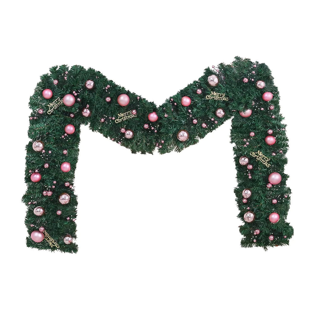 2.7 metre long pink artificial Christmas rattan vine decoration with small berries and leaves against a wall.