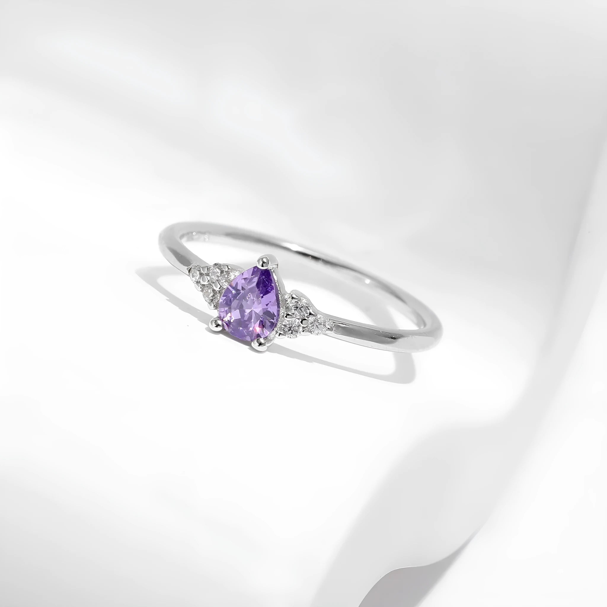 S925 sterling silver ring with purple crystal drop-shaped rhinestone on white background