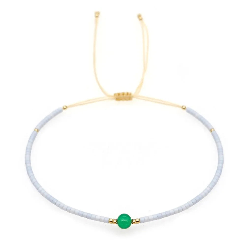 Handmade bohemian style bracelet with colourful geometric glass and coloured glaze beads.