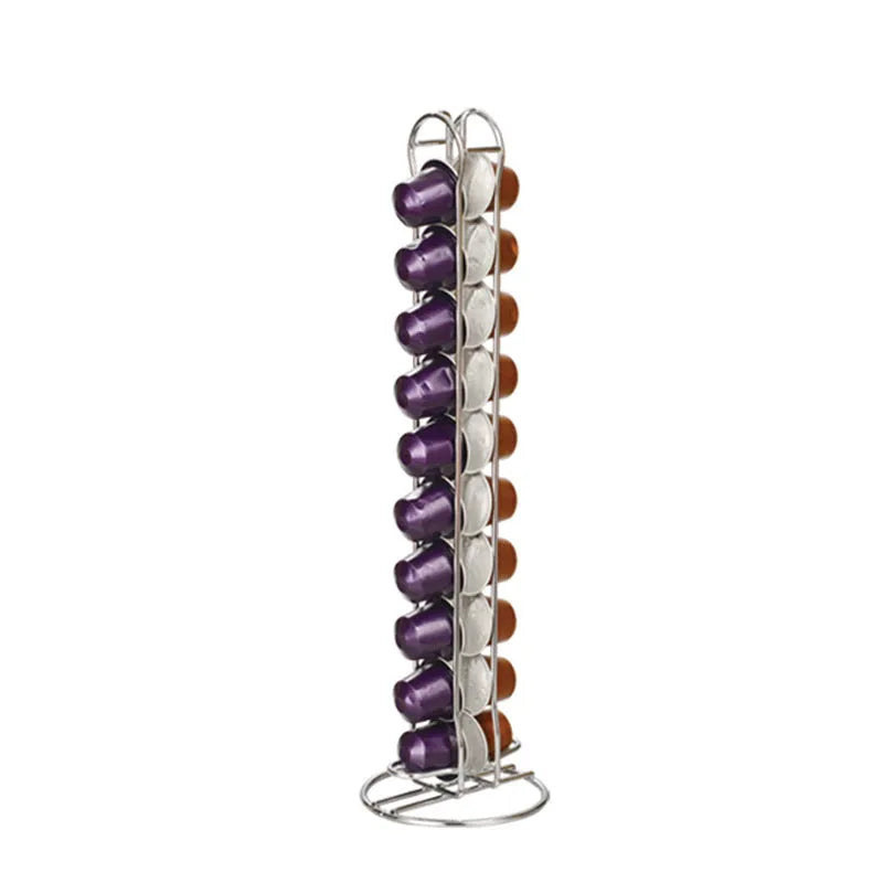Black wrought iron coffee capsule storage rack holding pods on shelves.