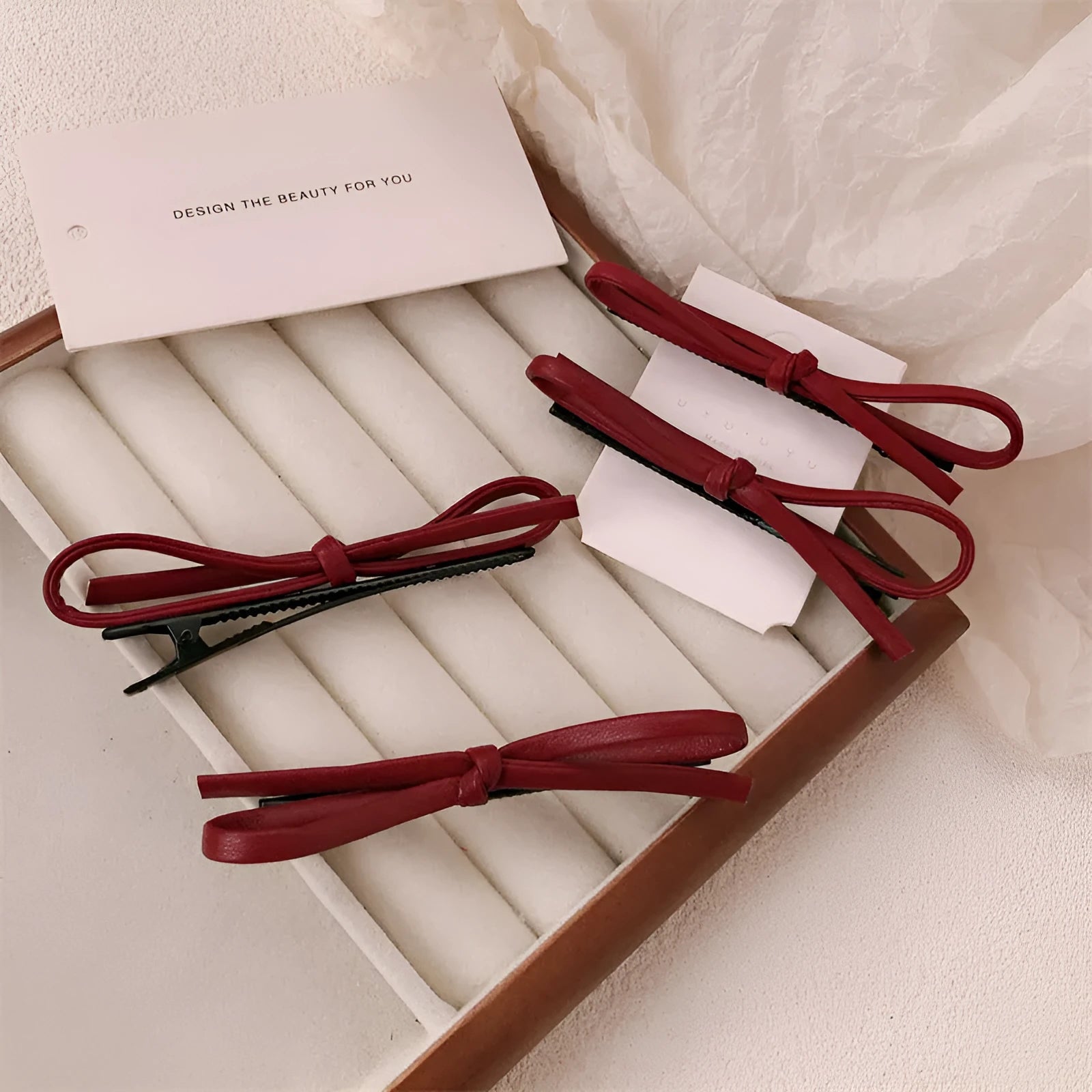 Wine red leather bow hair barrettes showing handcrafted details and bow design