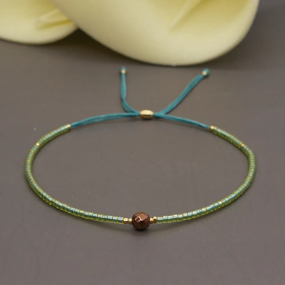 Handmade bohemian style bracelet with colourful geometric glass and coloured glaze beads.