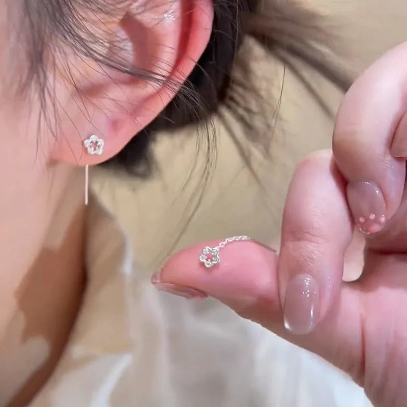 Silver flower stud earrings with hollow petal designs on alloy posts for women