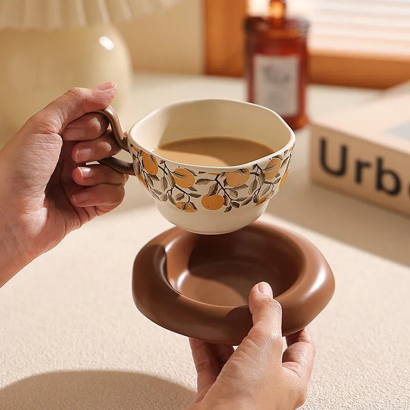 Antique style ceramic coffee cup and saucer set with medieval decoration in black or orange