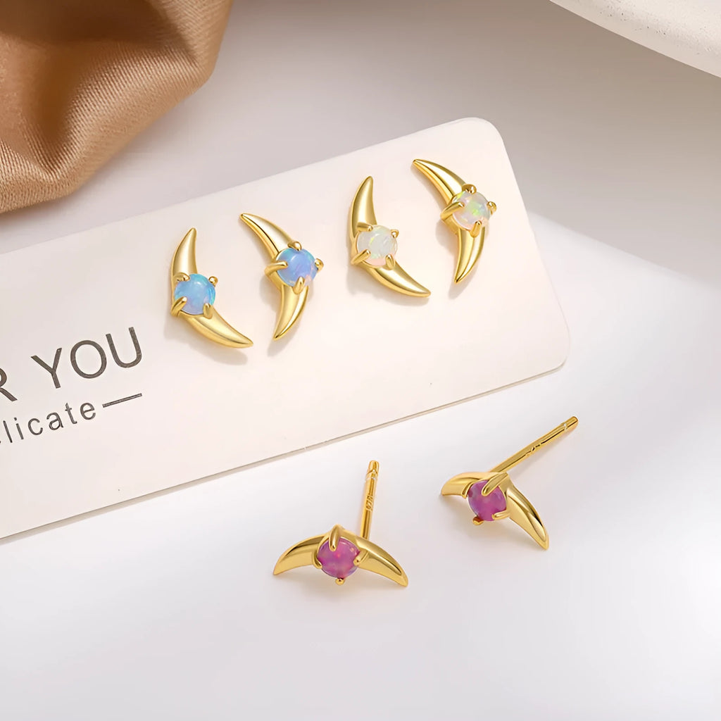 Women's geometric 925 silver earrings with blue stone in gold setting.