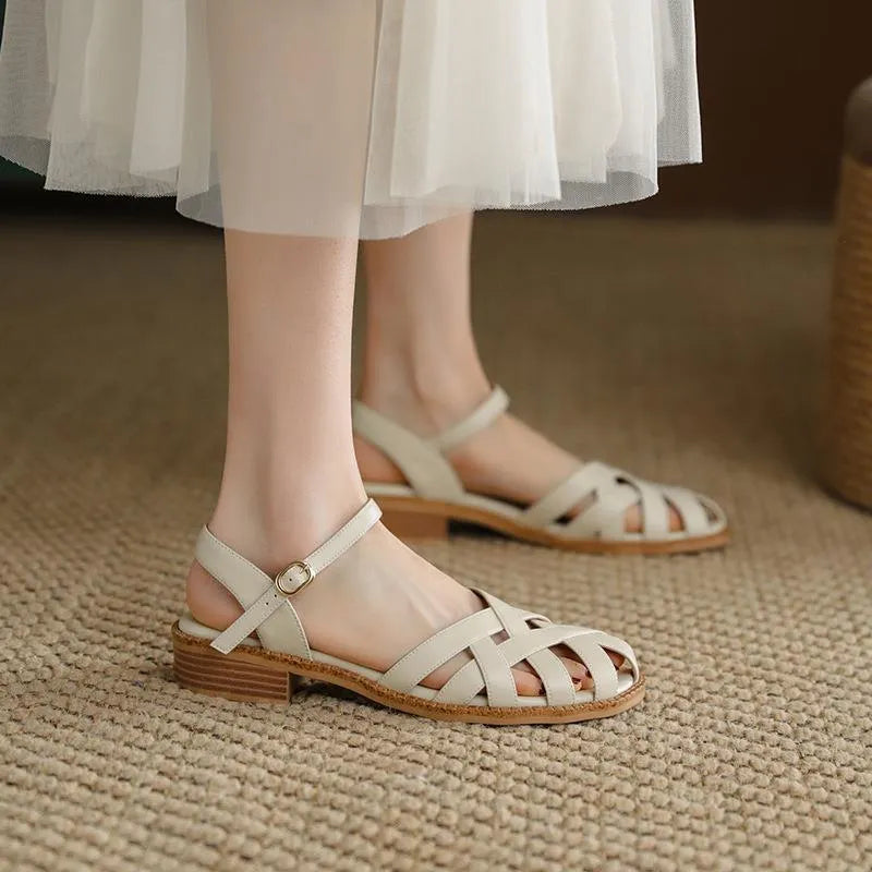 Women's flat closed toe sandals with word strap and buckle in beige colour