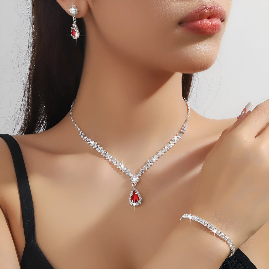 Claw chain necklace and matching drop earrings set with rhinestones in multiple colours.