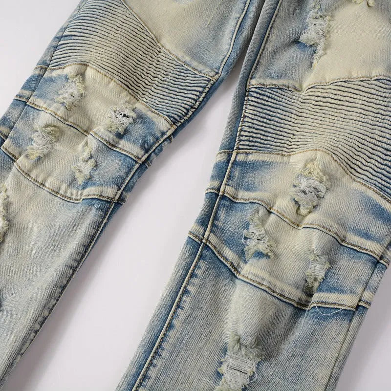 Light blue men's slim fit distressed jeans with hand-frayed details on a mid-waist, showing a zipper fly and straight leg cut.