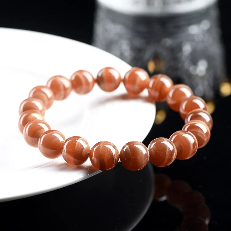 Natural Rhodochrosite round beads bracelet from Peru with geometric design and Ruyi elements