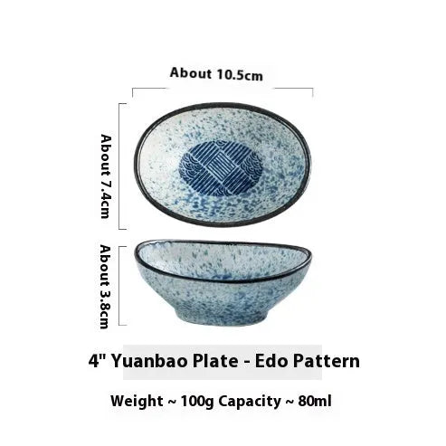 Oval Japanese ceramic sauce dipping bowl with traditional underglaze pattern on a wooden table.