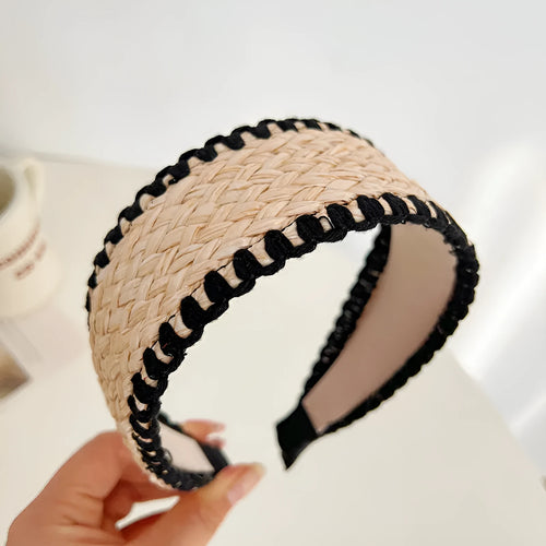 Bamboo woven wide brim hair band in black with bend and hitch details, side view on plain background