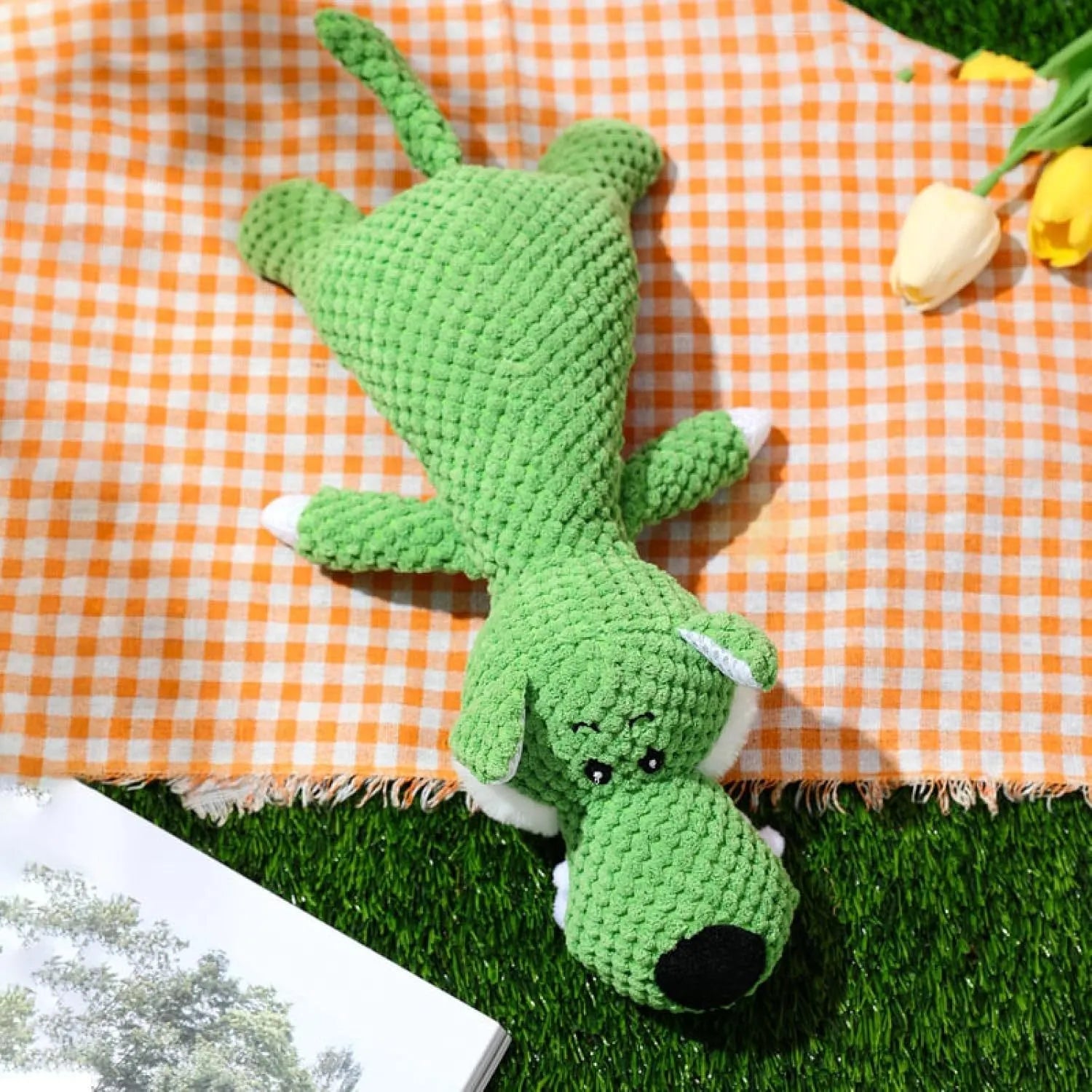 Grey plush dog toy shaped and textured like an ear of corn with visible kernels, lying on a plain surface.