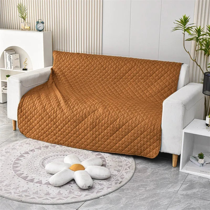 Reversible dog blanket couch cover in grey, laid flat on a sofa