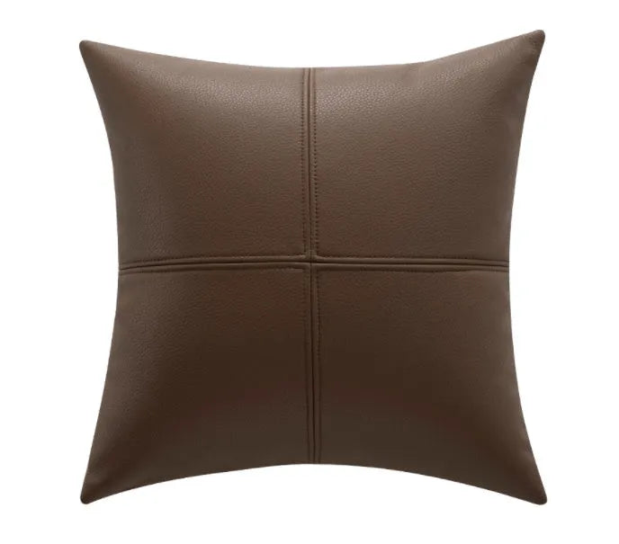 Soft cowhide leather pillow cover in a solid colour, shown in a Nordic style interior setting.