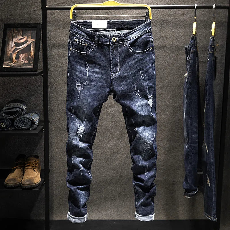 Men's slim-fit skinny jeans in dark blue cotton denim on a hanger.