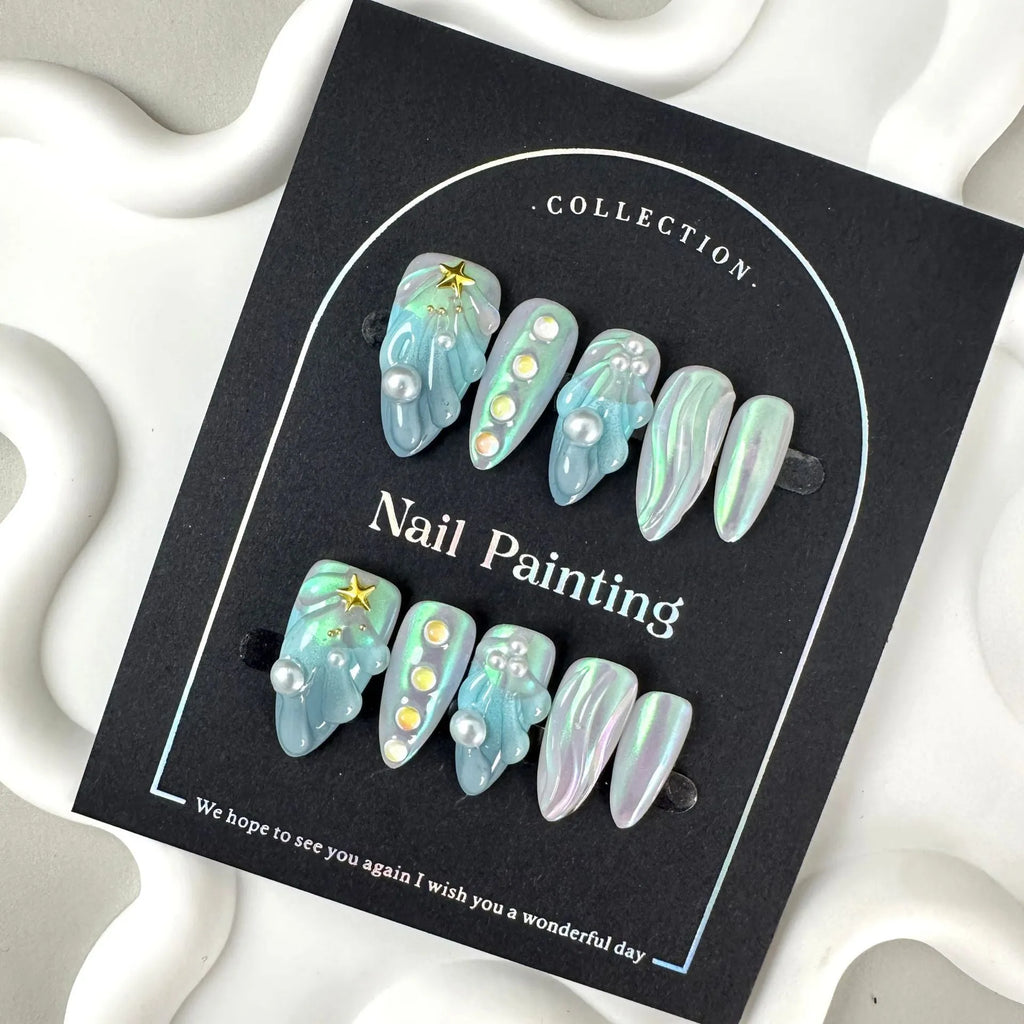 Blue plastic nail stickers and wearable nail armour pieces set on a white background.