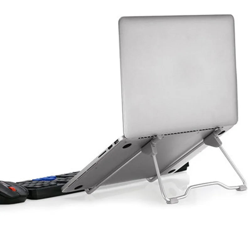 A grey aluminium alloy and plastic stand holding a mobile phone and a laptop at an adjustable angle.