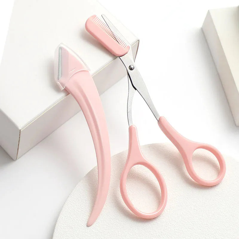 White and pink curved moon-shaped eyebrow trimming knife with a comb on a white background.