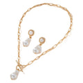 Gold-colour baroque pearl necklace and stud earrings jewellery set on display