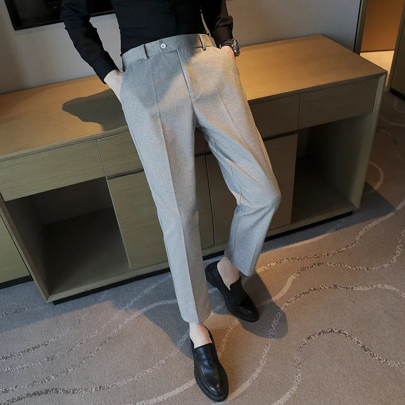 Straight-leg brown corduroy trousers with an elasticated waistband laid flat.
