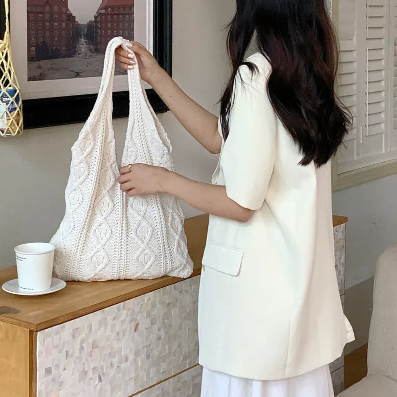 Women's crochet knitted shoulder tote bag in a solid colour with hollow retro design and double straps.