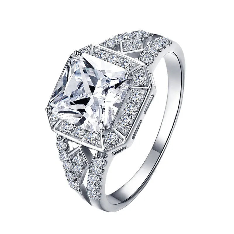 Women's geometric zircon ring with platinum finish on a copper band, showing hollow construction and quadrilateral design.