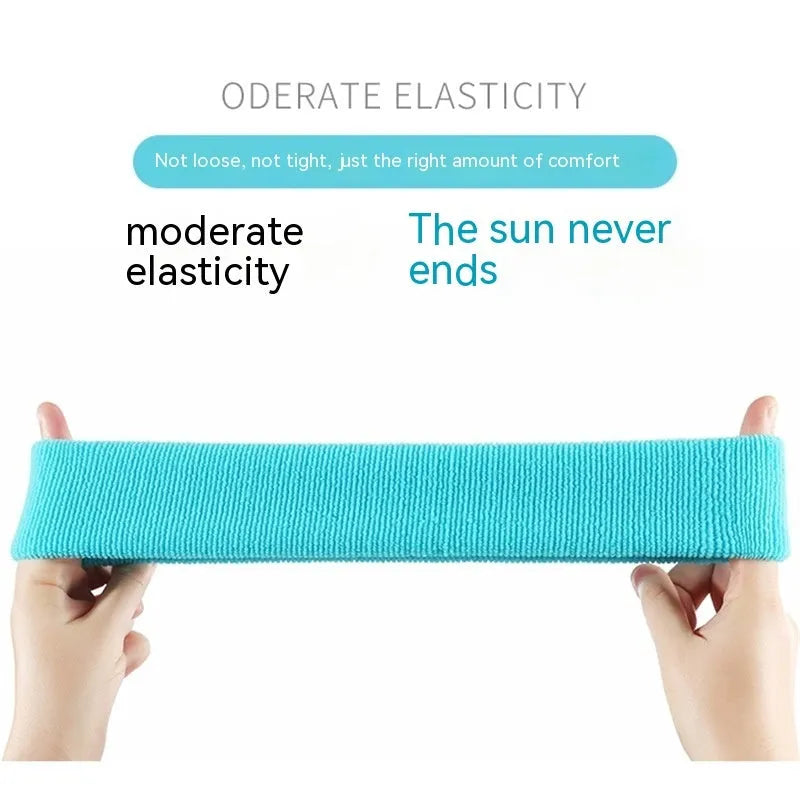 Elastic solid colour sports sweatband in black, shown stretched to demonstrate fit.