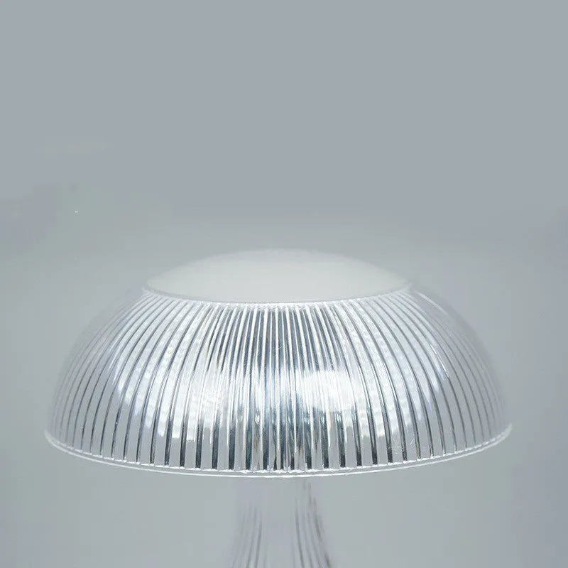 Small white touch-control night lamp with USB charging cable on wooden surface
