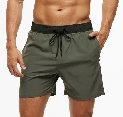 Men's blue athletic shorts with stitching waist detail, drawstring, zipper, and side pockets.