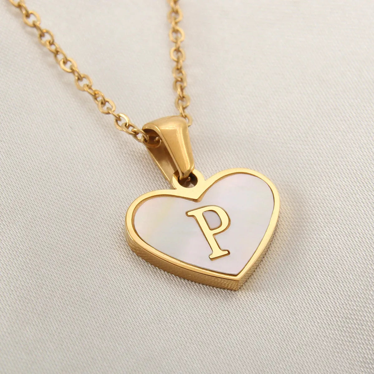 Gold heart necklace with white shell pendant and initial charm on 45cm adjustable chain