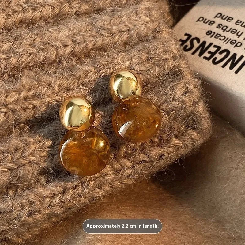 Handmade alloy earrings set showing three geometric designs: irregular amber, wafer disc and water drop tigereye styles