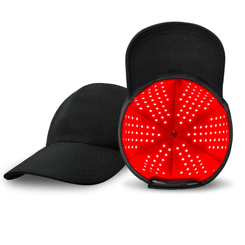 Black infrared duckbill hair growth cap with red LED lights and separate controller on table