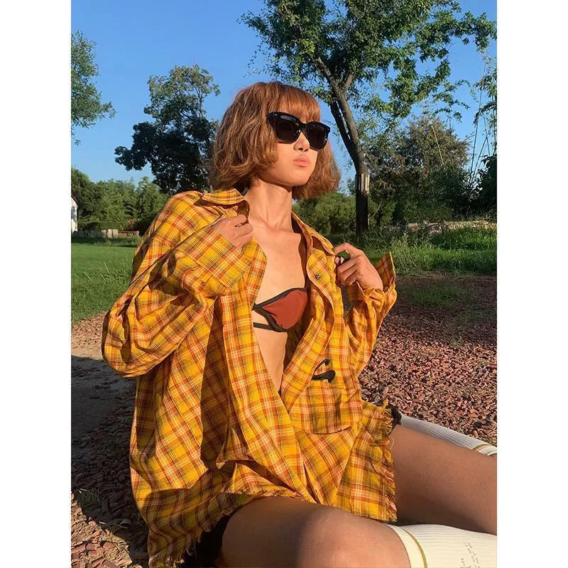Man and woman modelling a loose-fit dopamine yellow plaid casual shirt.
