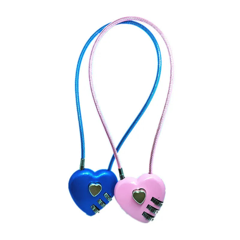 Peach heart shaped combination lock with a black steel rope cable coiled on a table.