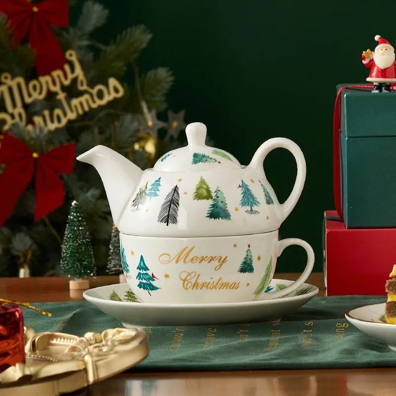 Ceramic gold-plated Christmas teapot set with snowflake design, including pot on dish and cup on dish with spoon, in gift box.