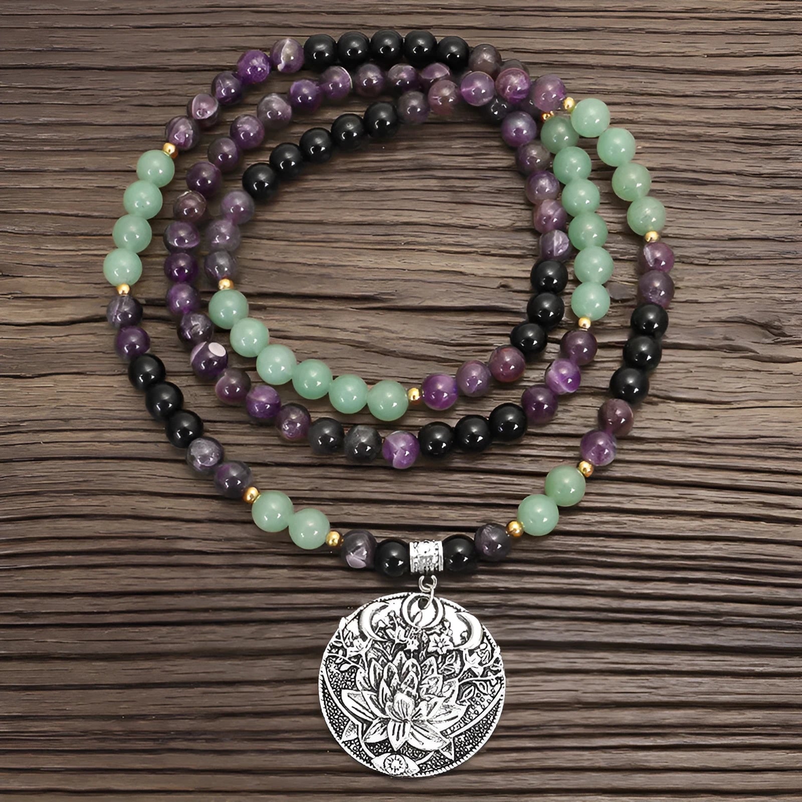 Yoga necklace with geometric lotus pendant and stone bead chain alongside a matching bracelet