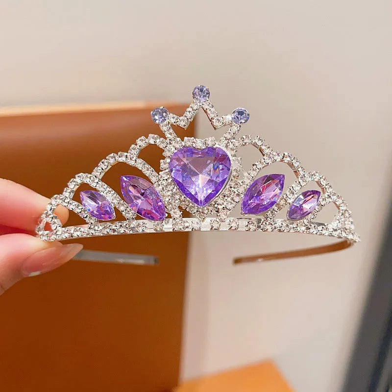 Children's electroplated alloy crown headband with pink crystals, shown on a model for scale.