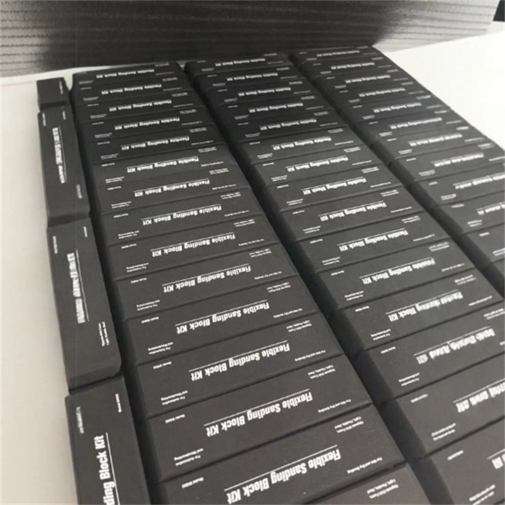 Set of seven black metal frosted blocks arranged together on a surface.