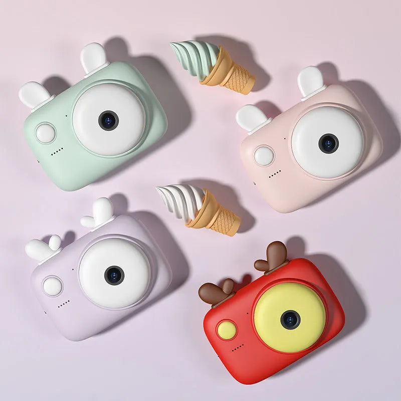Macaron-themed A2 kids digital camera with lanyard, shown in green colour with 2.4-inch screen.