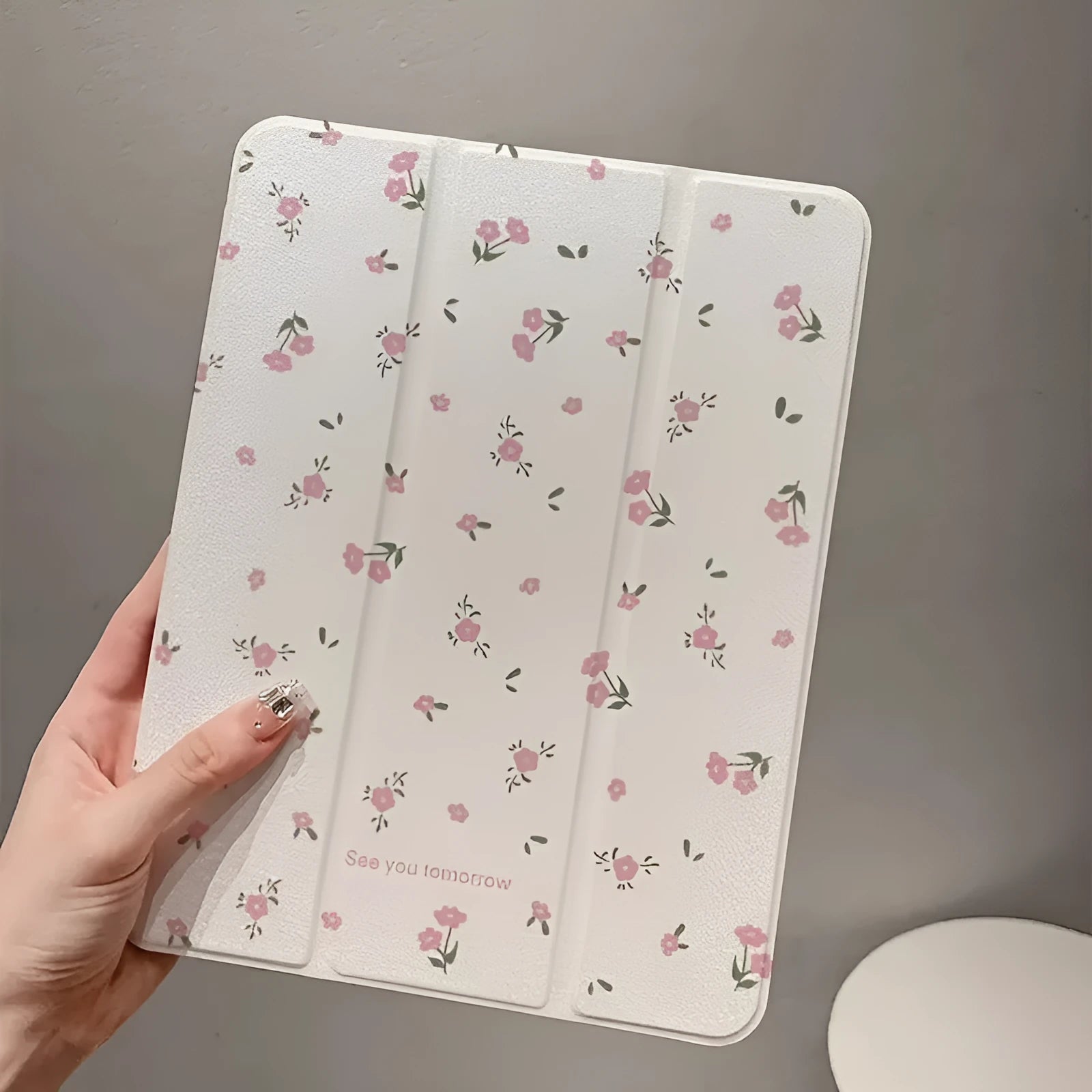 Transparent floral tri-fold iPad case with magnetic stand bracket shown open