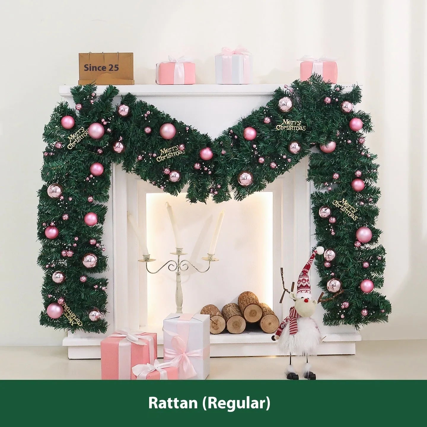 2.7 metre long pink artificial Christmas rattan vine decoration with small berries and leaves against a wall.