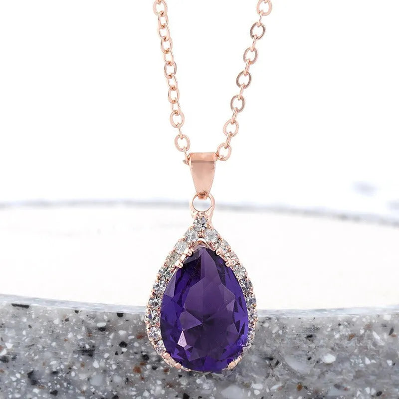 Women's pink rhinestone drop necklace with rose gold electroplated finish and geometric design