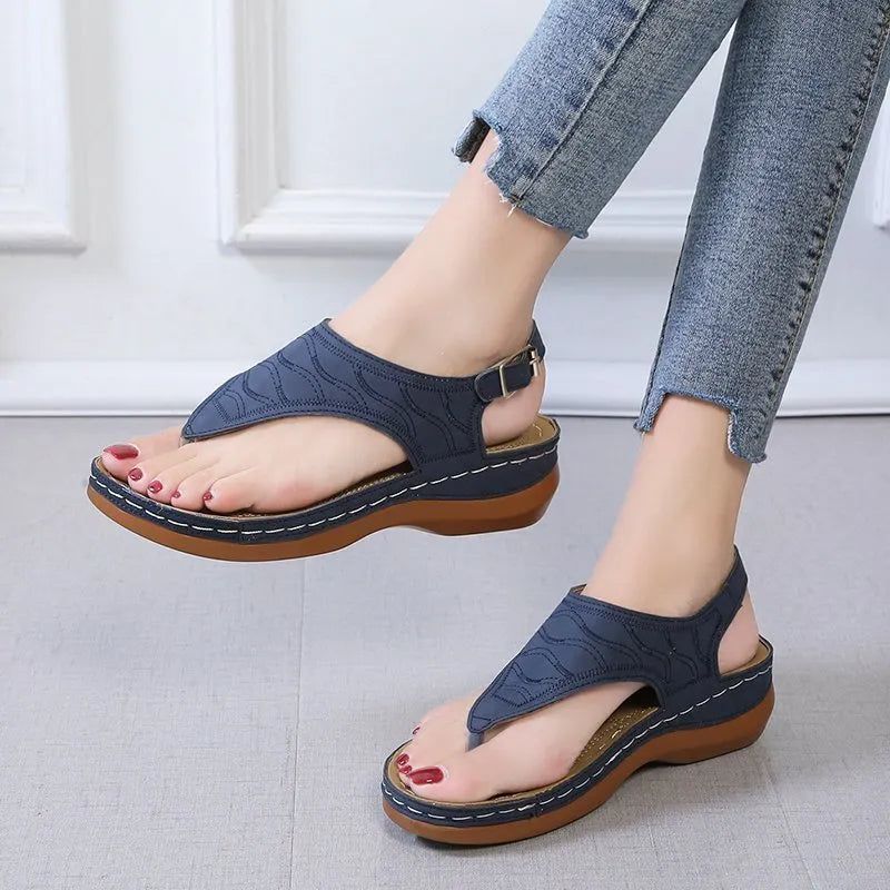 Women's casual wedge heel flip flop sandals with adjustable back strap in red vegan leather