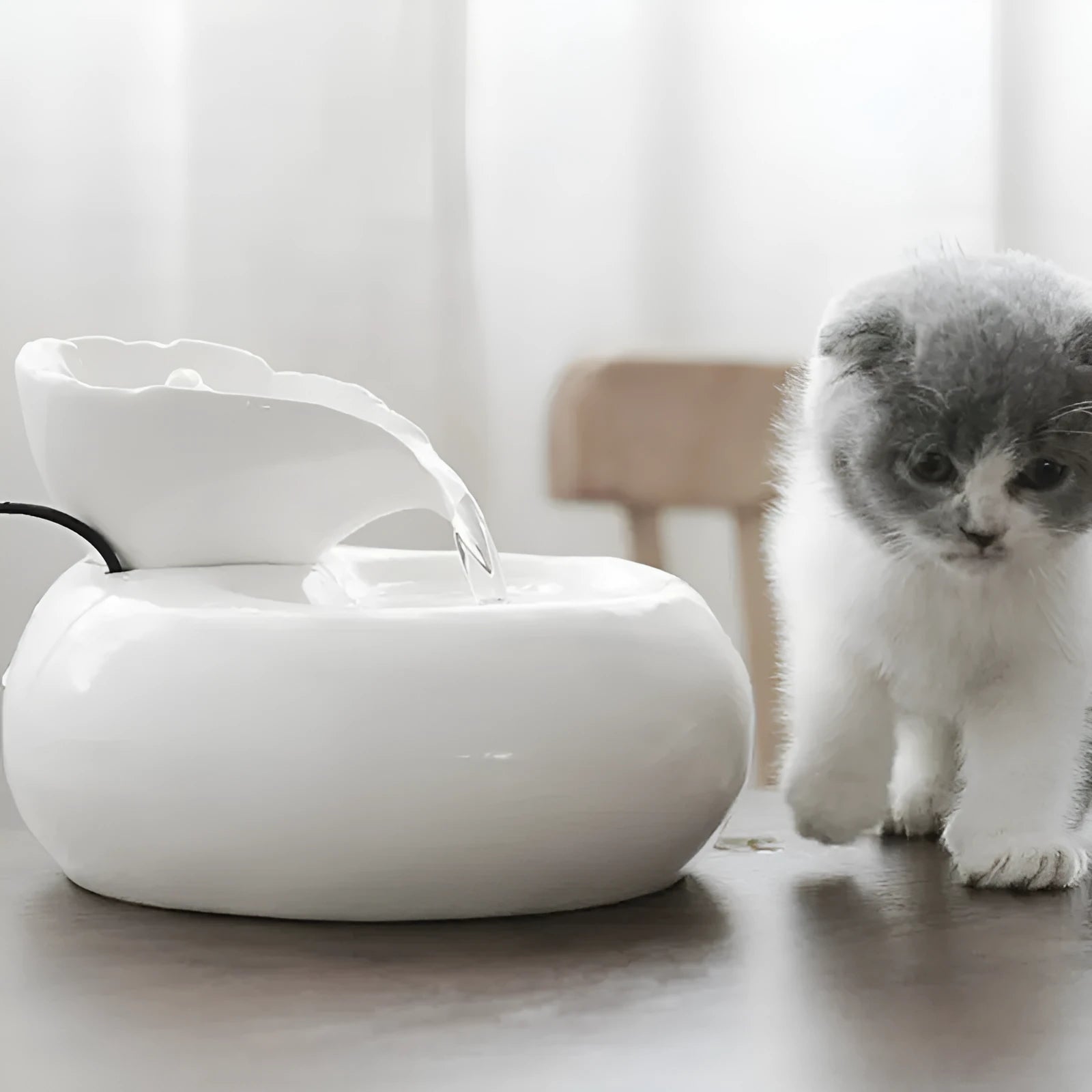White ceramic automatic cat water dispenser with leaf-shaped bowl and pump